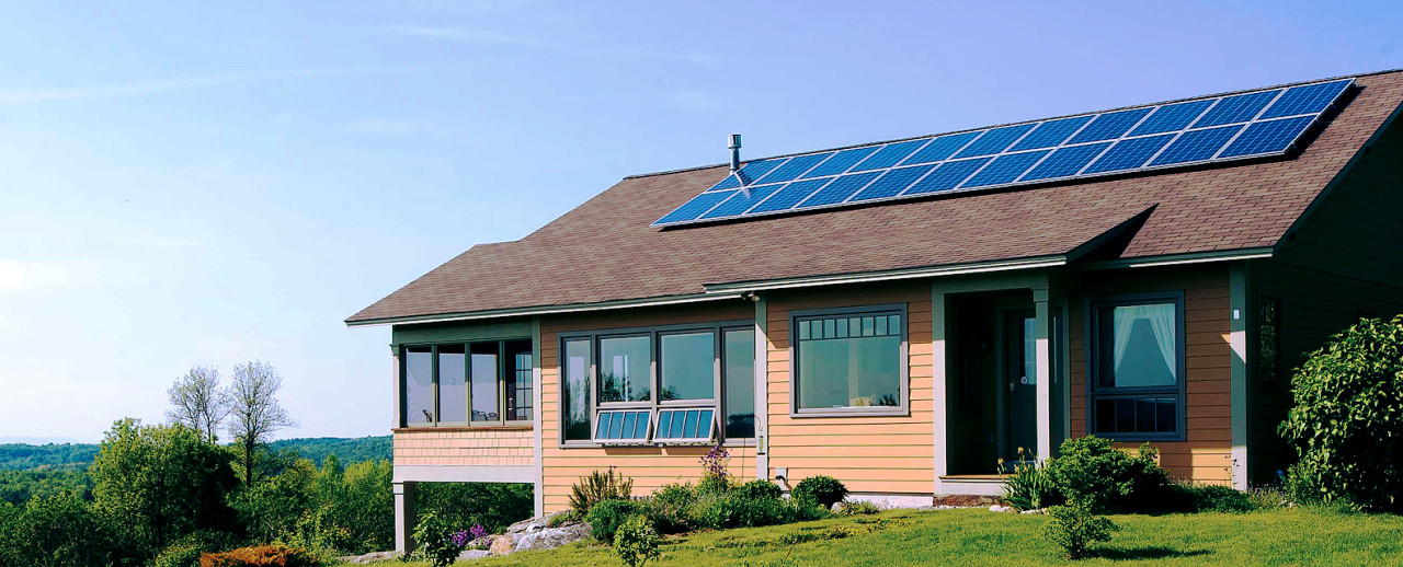 Image of a nice home on a hill top with solar panels